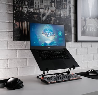 a laptop computer monitor and keyboard on a desk