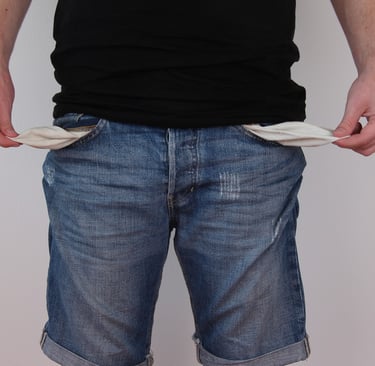 a man in a black shirt and jeans shorts, with empty pockets