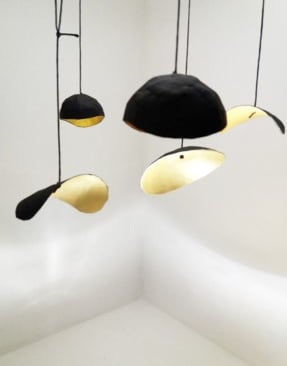 a ceiling light with a black and gold shade
