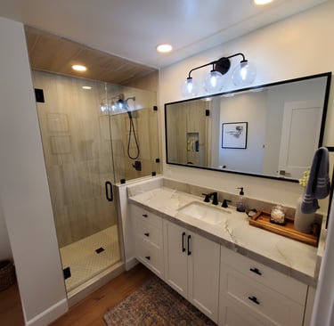 Compete bathroom renovation with recessed lights, sleek shower and counter top. personalized bathrooms Colorado Springs.