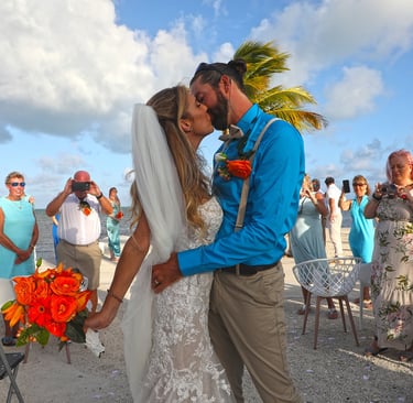 bride and groom walking down the aisle kissing in key biscayne