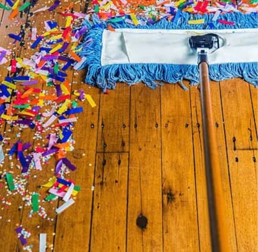 Broom cleaning up confetti