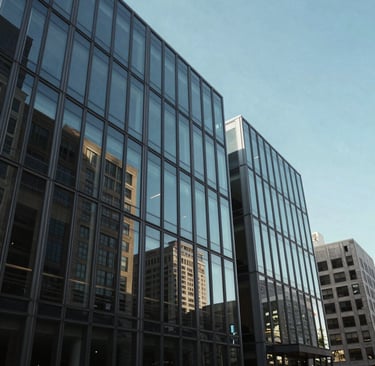 The exterior of a modern, glass-fronted foundation office in a North American city, reflecting a clear blue sky, exuding authority and trust.