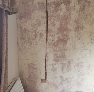 A vertical channel cut into a plastered wall for electrical wire chasing and home renovation.