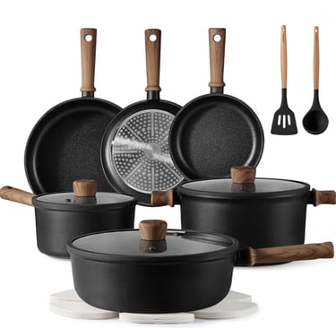 a group of pots and pans with a variety of cooking utensils