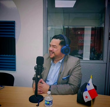 hector villamil with headphones on a microphone