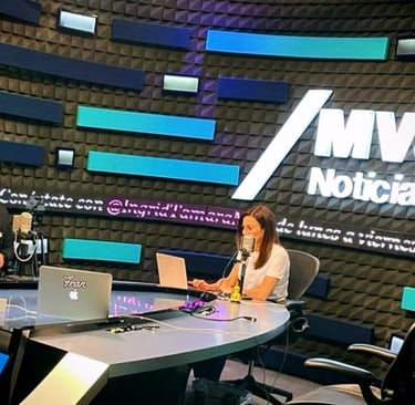 a man and woman sitting at a table with laptops