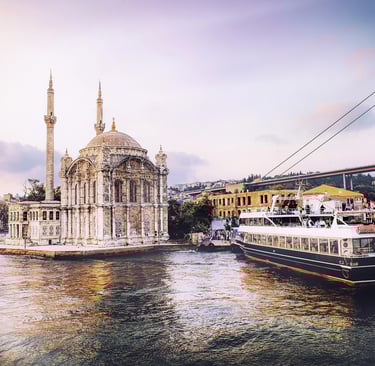 Ortaköy Mosque and a boat on the Bosphorus with the Bosphorus Bridge in Istanbul.