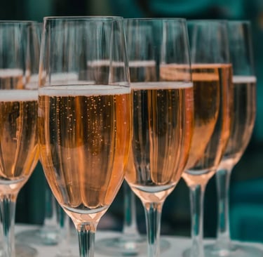 a row of wine glasses sitting on top of a table