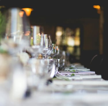 focused photo of wine glasses lined on table