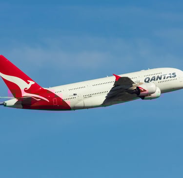 red and white air plane in mid air during daylight