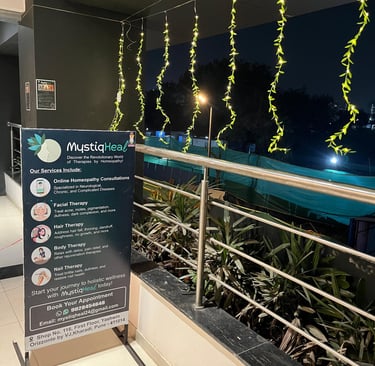 A clear sign positioned on a building's balcony, visible to those walking by, conveying important information