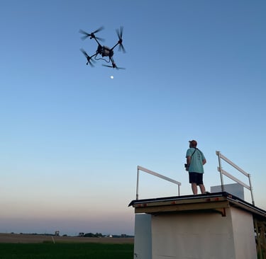 Large Crop Drone Flying at dusk under clear blue sky