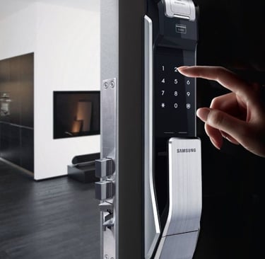 a person's hand is pressing a keypad on a door
