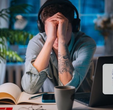 a man with headphones and headphones on a laptop computer
