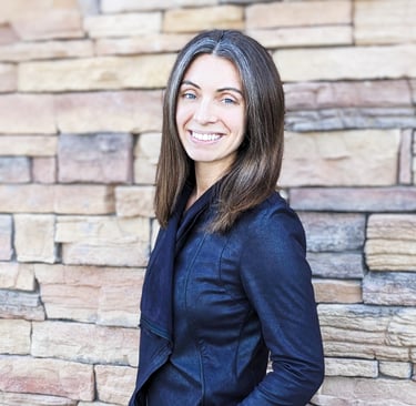 a headshot of Danielle in front of a brick wall