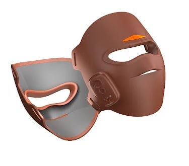 A sleek, high-tech brown LED facial mask showing its ability to reach 360 degrees.