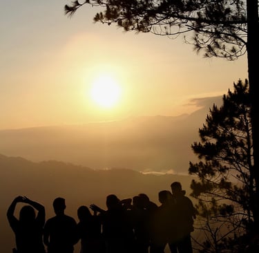 a group of people standing on a mountain top