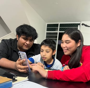 Three students learning English on their cellphones using digital Apps.