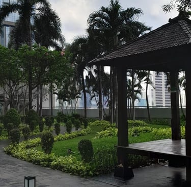 a park bench with a red umbrella and a red umbrella