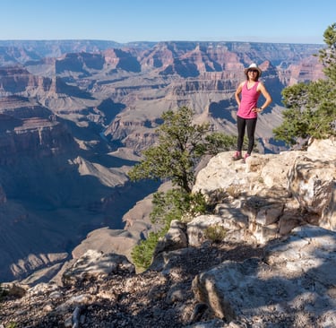 Janet standing on a cliff overlooking the Grand canyon