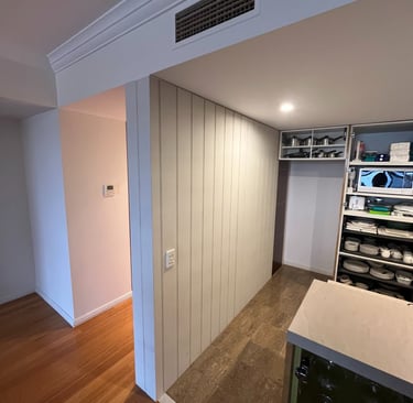 Before and after interior renovation with custom timber wall cladding