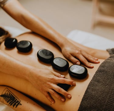 Hot stone massage treatment for guests (photo courtesy of pexels)