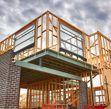 a house being built with a large wooden frame