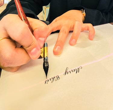 Live calligrapher performing calligraphy for luxury brand activation