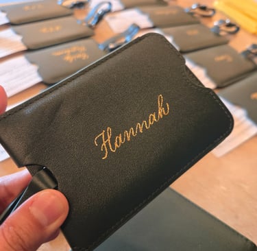 Hot foiling modern script on luggage tag by Handwritten by Belle at NYC corporate event.