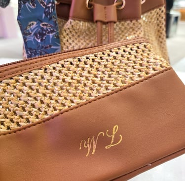 Hot foiling on leather bag at Saks Fifth Avenue by NYC calligrapher Handwritten by Belle.