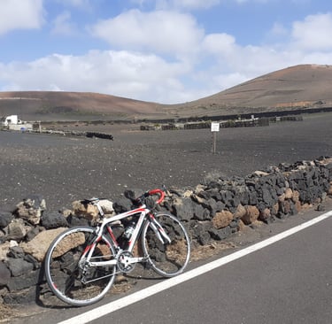 a bicycle parked next to a stone wall