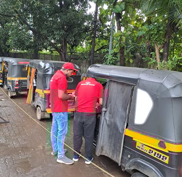 a man and a woman are standing in front of a line of tuk tu