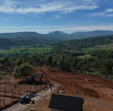 a construction site with a large amount of dirt and a tractor