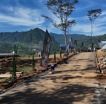 a dirt road with a mountain in the background