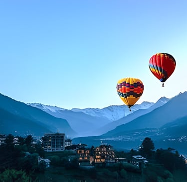 a two of hot air balloons in the mountains in Manali