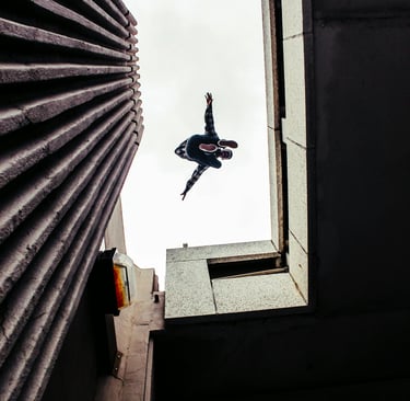 Dancer jumping between buildings