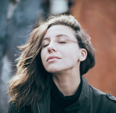 a woman with long hair and a black jacket