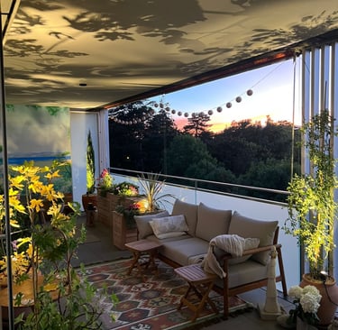 a couch sitting on a patio with a view of the ocean