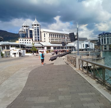 a man walking down a path with a large black object