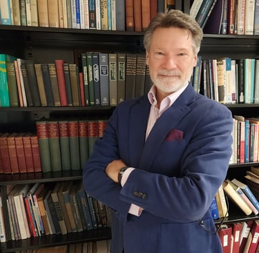 J. Andrew Kuypers by bookcase