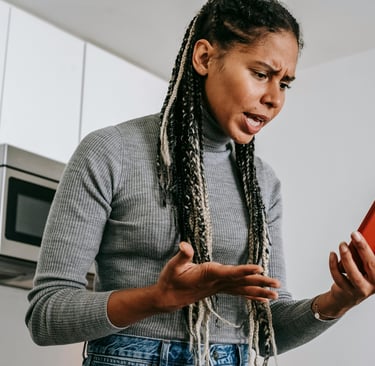 a woman with dreadlocks and a cell phone
