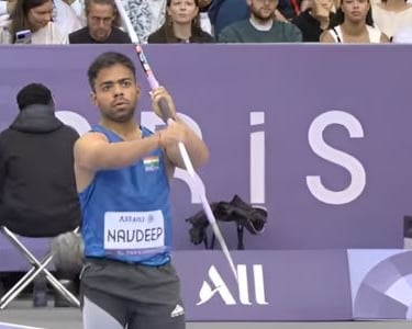 a man holding a pole pole in front of a crowd