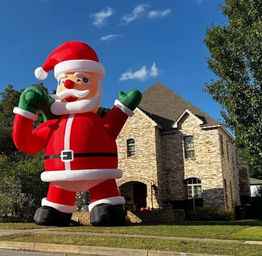 a giant inflatable santa clause in front of a house