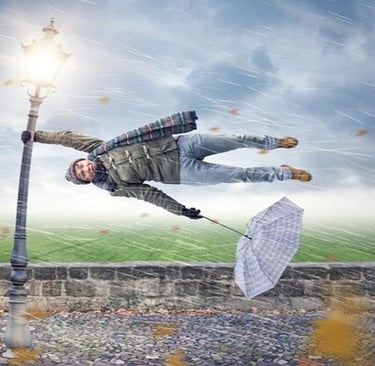heavy wind with person holding onto pole