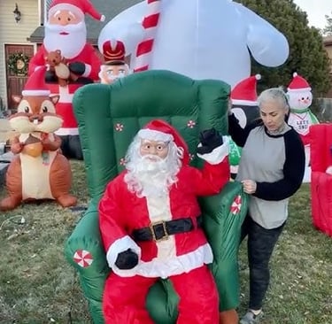 Woman setting up inflatable Christmas displays