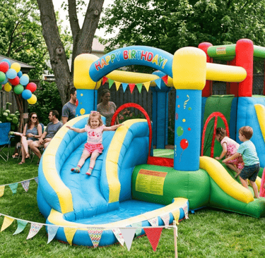 inflatable water slide in a backyard birthday party with small children