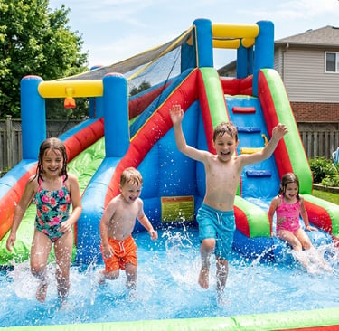 kids splashing in the pool area of an inflatable water slide in a backyard