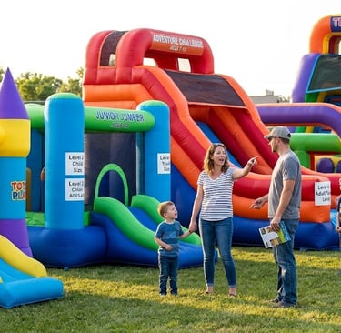 Parents comparing different age levels for bounce houses