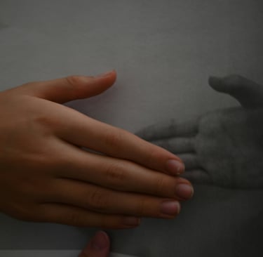Close-up of two hands resting near each other, representing subtle emotional connection and safety